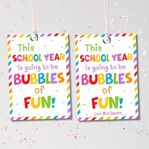 May include: Two rectangular gift tags with the text "This SCHOOL YEAR is going to be BUBBLES of FUN!" in colorful letters. Each tag has a rainbow border and a string for hanging.