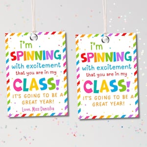 May include: Two rectangular gift tags with a colorful border and the text "I'm SPINNING with excitement that you are in my CLASS! It's going to be a great year! Love, Miss Danisha."
