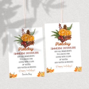 May include: Two printable gift tags with a holiday theme. The tags feature a watercolor illustration of oranges, cinnamon sticks, cranberries, and pine cones. The text on the tags reads "Holiday Simmering Potpourri" and includes instructions for making the potpourri. The tags are perfect for adding a festive touch to your holiday gifts.