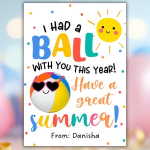 May include: A white greeting card with the text "I HAD a BALL WITH YOU THIS YEAR! Have a great summer!" in colorful bubble letters. A smiling sun and beach ball with heart-shaped sunglasses are also featured. The card is signed "From: Danisha."