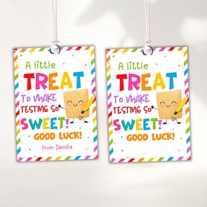 May include: Two rectangular gift tags with a colourful border and the text "A little TREAT to make testing so SWEET! Good Luck!" A cartoon cookie character holds a pencil. The tags are connected by a white string.