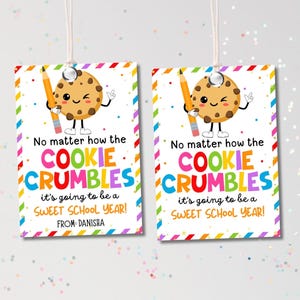 May include: Two rectangular gift tags with a cartoon cookie character holding a pencil. The tags have a colorful border and the text "No matter how the COOKIE CRUMBLES it's going to be a SWEET SCHOOL YEAR!" and "FROM: DANISHA".