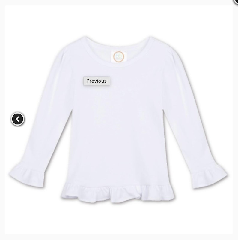May include: A white long-sleeved shirt with ruffle detailing at the cuffs and hem. The shirt has a round neckline and a small circular logo near the neckline. The word "Previous" is displayed on a small rectangular label.
