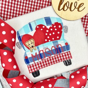 May include: A red and white checkered truck with a blue and white plaid interior. The truck is carrying two red hearts with white polka dots and a yellow dog. The truck has the name "Mason" embroidered on the back.
