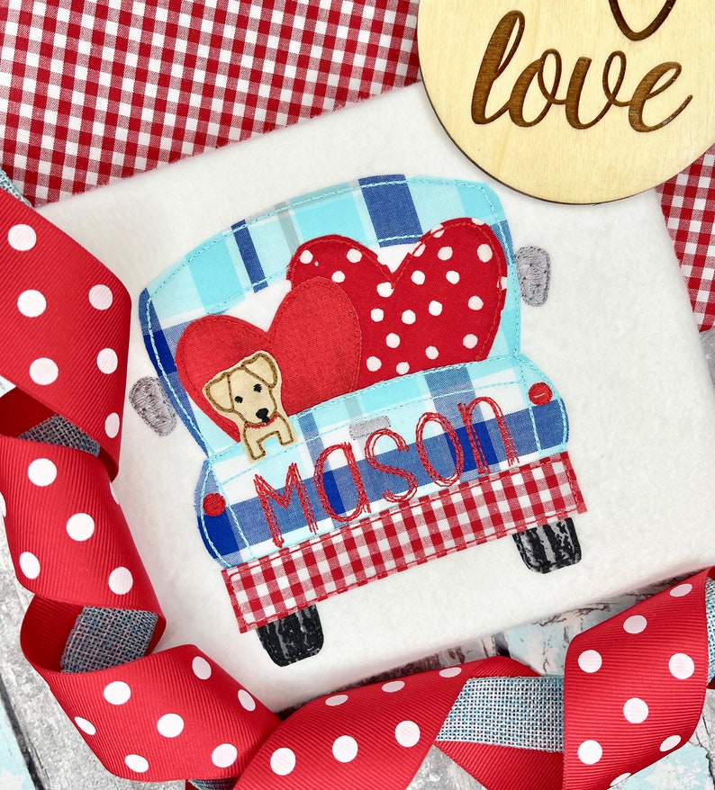 May include: A red and white checkered truck with a blue and white plaid interior. The truck is carrying two red hearts with white polka dots and a yellow dog. The truck has the name "Mason" embroidered on the back.