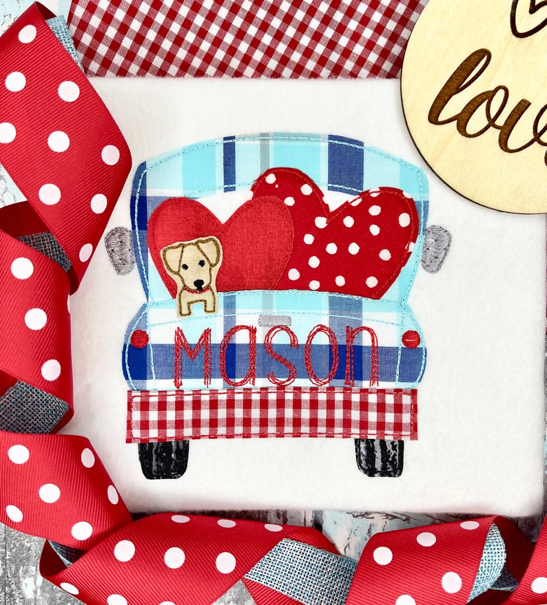 May include: A blue and white plaid pickup truck with a red heart and white polka dot heart in the bed. A small yellow dog is sitting in the bed of the truck. The truck has the name "Mason" embroidered on the back.
