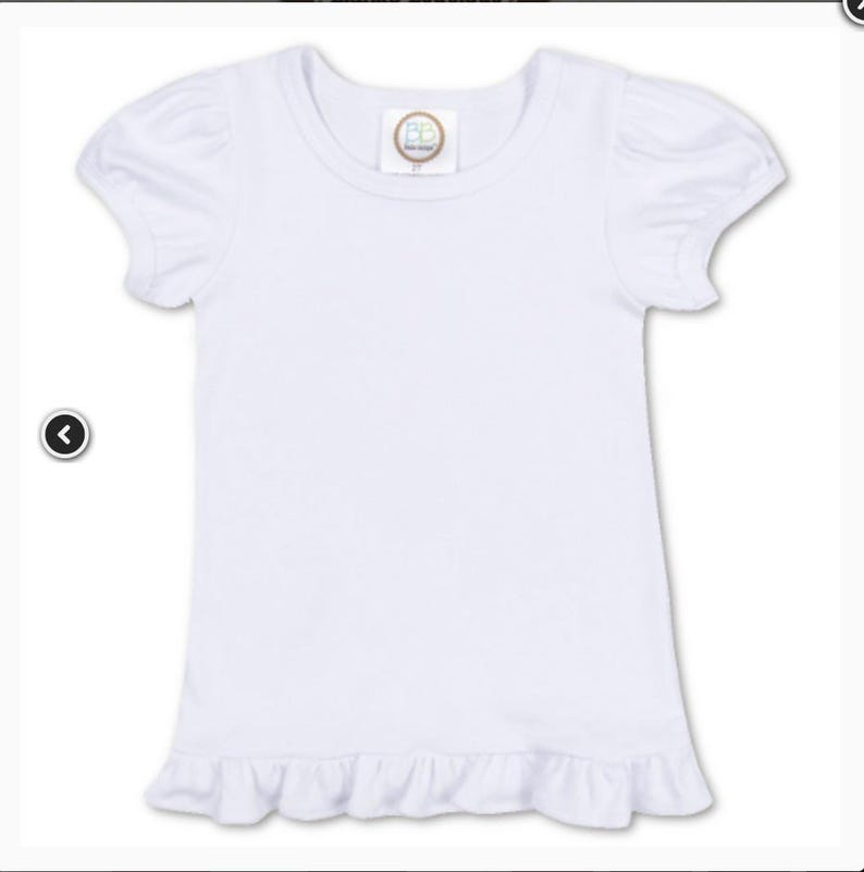 May include: A white short-sleeve shirt with a round neckline and ruffled hem. The sleeves have a puffed design. A small, circular tag is sewn on the neckline.