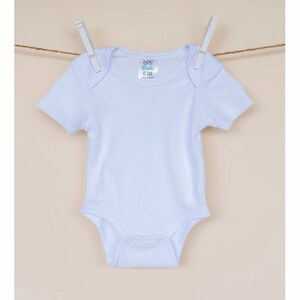 May include: White baby onesie with short sleeves and snaps at the bottom. The onesie has a label that says "CCB Blanks 0-3M Made in China".