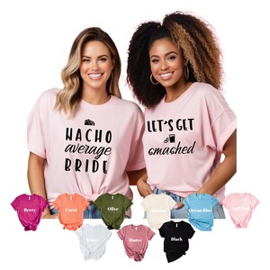 May include: Two pink t-shirts with black text. The first shirt says "Nacho average bride" with a taco graphic. The second shirt says "Let's get smashed" with a margarita graphic. The shirts are displayed on a white background with a variety of colour options below.
