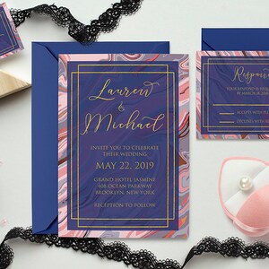 May include: A wedding invitation suite with a blue and pink marble design. The invitation features the names "Lauren & Michael" in gold script. The RSVP card includes the text "Respond" in gold script and the date "March 18, 2019".