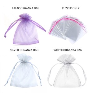 May include: Four organza bags in different colors: lilac, silver, white, and clear. The clear bags are labeled "Puzzle Only".