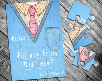 Op de afbeelding: Een blauwe en witte puzzelkaart met een aquarel-illustratie van een colbert, stropdas en zak. De tekst op de kaart luidt "Michael, Wil je mijn getuige zijn? Met liefde Edward".