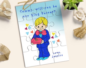 May include: A blue and white puzzle card with a cartoon boy holding a ring pillow. The card says "Tommy, will you be our Ring Bearer? Love, Jessica".