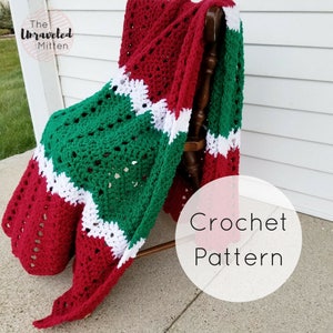 May include: A red, white, and green crochet blanket draped over a wooden chair. The blanket has a repeating pattern of squares. The text "Crochet Pattern" is written in white on a white circle.