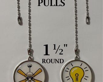 May include: Two round 1 1/2 inch double-sided fan and light pulls with silver metal chains. One pull features a yellow ceiling fan graphic, and the other features a yellow light bulb graphic. Text reads DOUBLE-SIDED FAN & LIGHT PULLS.