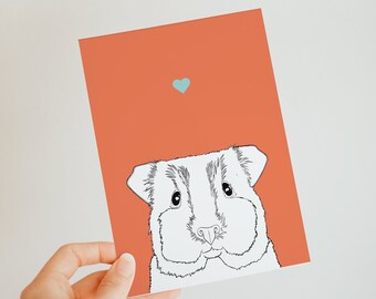 May include: A card with a cute cartoon guinea pig illustration on a coral background. A small blue heart is in the top center of the card.