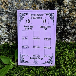 May include: A rectangular light purple spell slot tracker card featuring black text and decorative flourishes. The card includes fields for Spell Slot Tracker, Spell Atk Bonus, Spell Save DC, and levels 1st through 9th, with Jhotun's Forge branding.