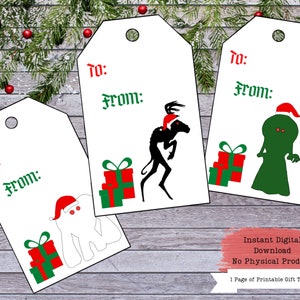 Puede incluir: Tres etiquetas de regalo imprimibles con una criatura en blanco y negro con un gorro de Pap&aacute; Noel rojo, una criatura verde con un gorro de Pap&aacute; Noel rojo y una criatura blanca con un gorro de Pap&aacute; Noel rojo. Cada etiqueta tiene las palabras "Para:" y "De:" impresas en ella. El texto "Descarga digital instant&aacute;nea Sin producto f&iacute;sico 1 p&aacute;gina de etiquetas de regalo imprimibles" est&aacute; impreso en la parte inferior de la imagen.