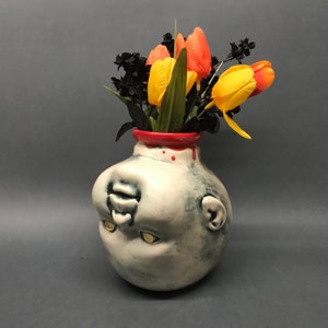 Decapitated Baby Head Vase