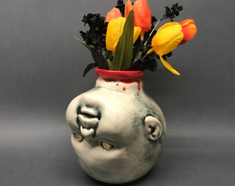 Decapitated Baby Head Vase