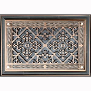 May include: A decorative cast iron vent cover with a black frame and a copper-colored, intricate design. The design features a repeating pattern of quatrefoils and crosses.