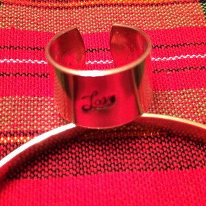 Love copper band ring with k m initials on the ends.