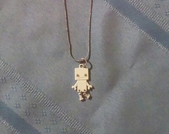 A White Robot on a Silver Necklace