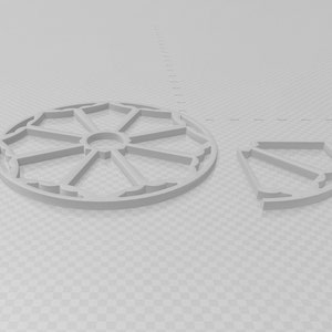 Puede incluir: Un diseño geométrico circular gris claro con un patrón segmentado y una pieza de cuarto de círculo a juego. El diseño presenta una serie de formas conectadas, creando una estética abierta. Las piezas son probablemente para un proyecto artesanal o decorativo.