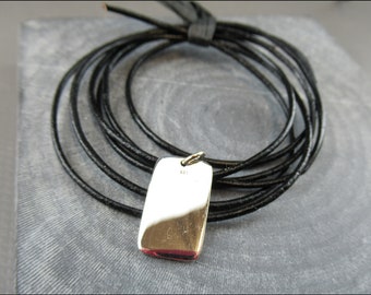 Real silver tag as a pendant, with a leather strap or with a real silver chain of dots.