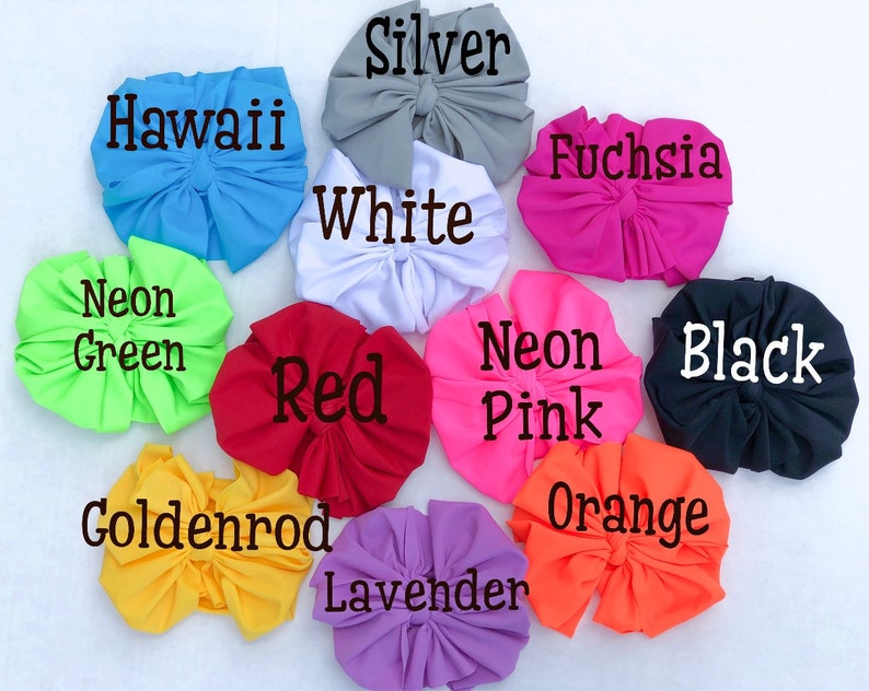 May include: A variety of colors of fabric scrunchies, including neon green, red, goldenrod, lavender, orange, neon pink, black, fuchsia, white, silver, and Hawaii blue.