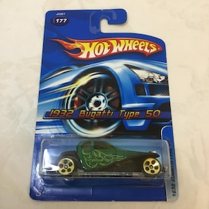 May include: A set of three ceramic mugs with a speckled, matte finish. The mugs are in shades of cream, light gray, and dark gray. Each mug has a simple, minimalist design and a rounded handle. The mugs are likely for coffee or tea.