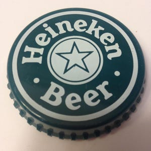 May include: Green bottle cap with a white star and the words "Heineken Beer" in a circle.