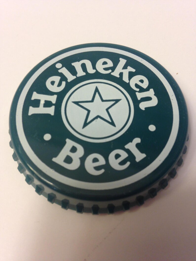 May include: Green bottle cap with a white star and the words "Heineken Beer" in a circle.
