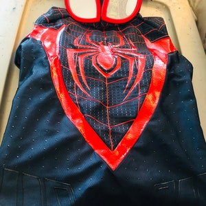 May include: Black and red Spider-Man costume with a red spider symbol and a black mesh mask.