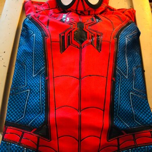 May include: Red and blue Spiderman costume with a black spider logo and a black web design. The costume includes a separate mask with a white eye area.