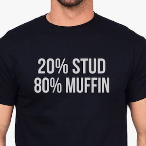 May include: A black t-shirt with the text "20% STUD 80% MUFFIN" printed in white.