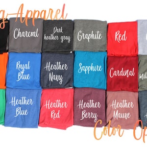 May include: A color chart showing different t-shirt colors available for purchase. The colors include black, charcoal, dark heather gray, graphite, red, gray, orange, royal blue, heather navy, sapphire, cardinal, heather military green, green, heather blue, heather red, heather berry, heather mauve, and dark heather.