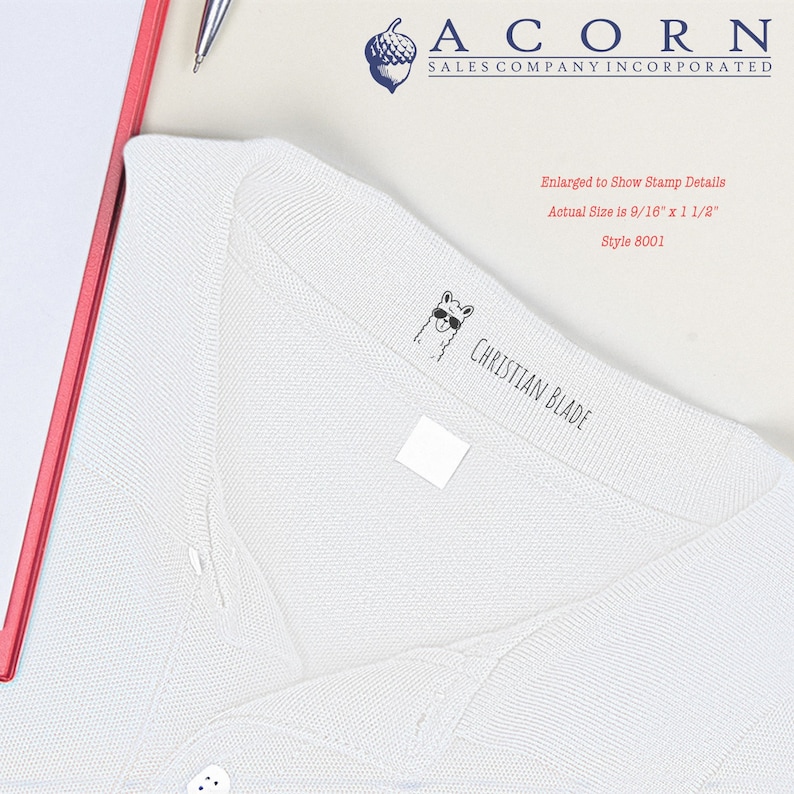 Self-inking kids stamp on a white shirt, showcasing a custom stamp for clothing. Ideal for labeling kids' clothing, this personalized stamp ensures easy identification and organization. Perfect for school uniforms and everyday wear.