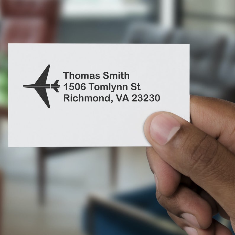 Business card with a pilot stamp design, ideal for frequent travelers. Features travel accessories theme, showcasing a sleek airplane icon. Perfect for those who love aviation and travel.