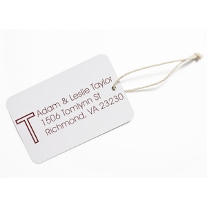 Custom rubber stamp on a white address label with Adam & Leslie Taylor, 1506 Tomlynn St, Richmond, VA 23230 text. Perfect for creating a personalized, customized stamp for your mailing needs.