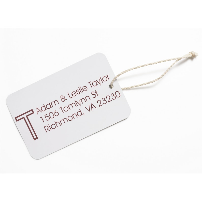 Custom rubber stamp on a white address label with Adam & Leslie Taylor, 1506 Tomlynn St, Richmond, VA 23230 text. Perfect for creating a personalized, customized stamp for your mailing needs.