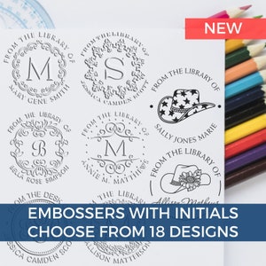 May include: A close-up of a white sheet of paper with several black and white rubber stamps. The stamps are round and feature different designs, including a floral wreath, a cowboy hat, and a monogram. The text "EMBOSSERS WITH INITIALS CHOOSE FROM 18 DESIGNS" is printed in blue at the bottom of the page.