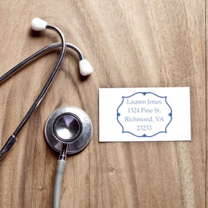 Stethoscope and business card on wooden table, ideal for real estate gifts. Perfect real estate closing gifts and customized gifts for new homes, adding a personal touch to new beginnings.