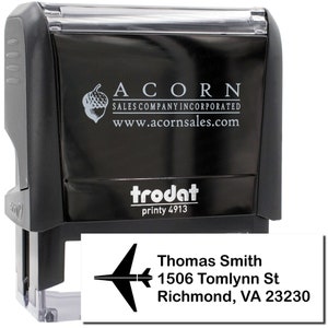 Travel-themed gift featuring a personalized address stamp with a travel stamp design. Ideal for travel enthusiasts, this custom stamp adds a unique touch to correspondence. Perfect for those who love personalized travel accessories.