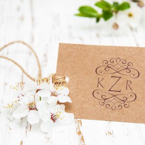 Monogram stamp on a rustic card with floral accents, ideal for personalized wedding gifts. Perfect stamp for invitations, adding elegance and charm to any special occasion.