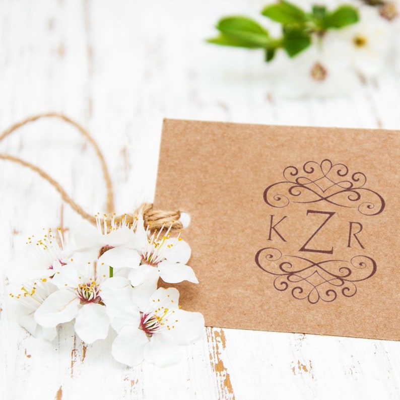 Monogram stamp on a rustic card with floral accents, ideal for personalized wedding gifts. Perfect stamp for invitations, adding elegance and charm to any special occasion.