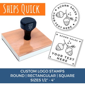 May include: A wooden stamp with a black handle and a design of two acorns on a branch. The stamp is labeled "Acorn Sales Co." and "Your Text Here". The text "Ships Quick" is in orange at the top of the image. The text "Custom Logo Stamps" is in white on a blue background. The text "Round | Rectangular | Square" is in white on a blue background. The text "Sizes 1/2" - 4" is in white on a blue background.