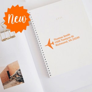 Custom stamp on a traveler's gift notebook, featuring a personalized address design. Ideal for those seeking a unique, customized stamp for travel enthusiasts. Perfect for adding a personal touch to travel journals and gifts.