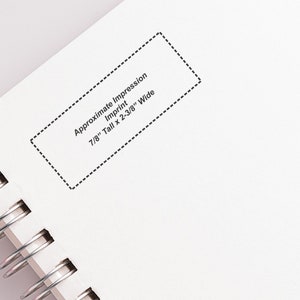 Elegant initial stamp on a notebook page, showcasing a unique address stamp design. Perfect as a personalized stamp gift for stationery enthusiasts, offering a stylish touch to letters and documents.