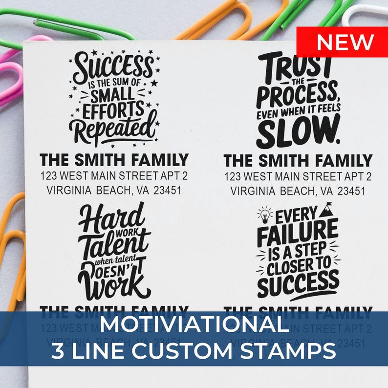 Four sample custom address stamp designs with motivational quotes and “The Smith Family” address, displayed on paper with colorful paper clips; text reads “Motivational 3 Line Custom Stamps” with a red “NEW” label.